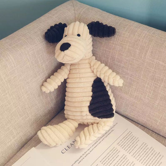 Knitted dog toy on a book with a beige couch background
